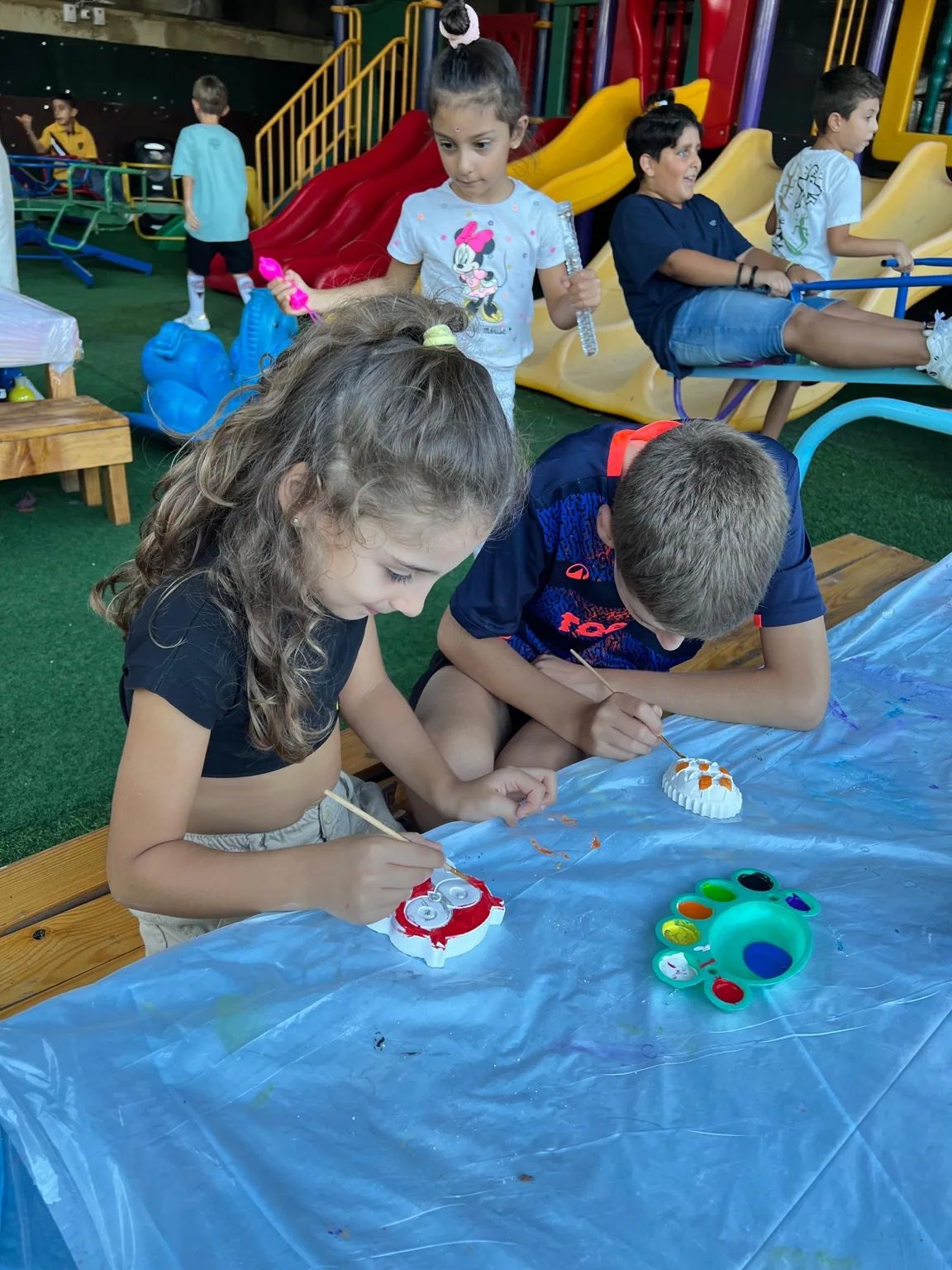 Children painting in the family play area